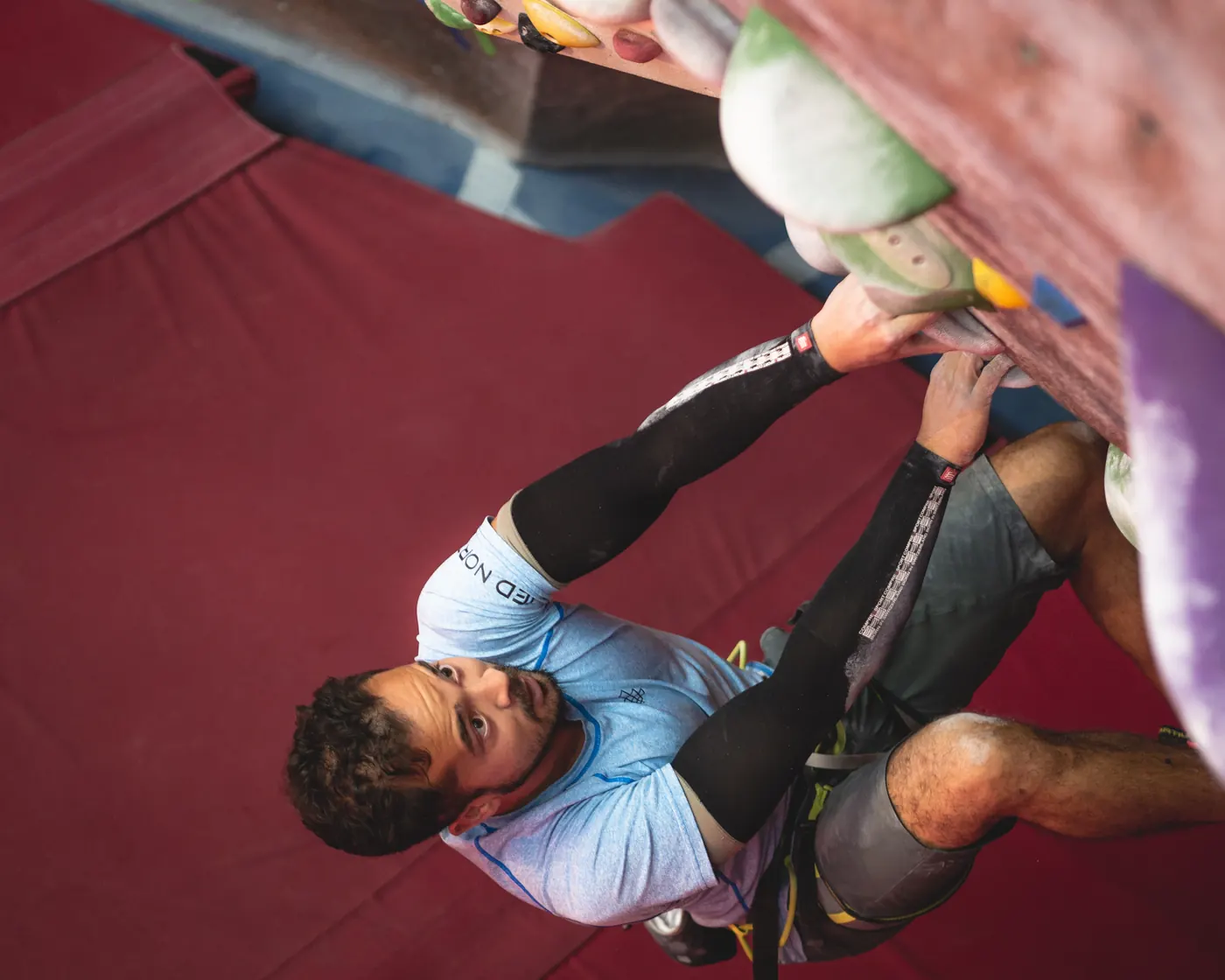 Zia climbing an indoor bouldering wall