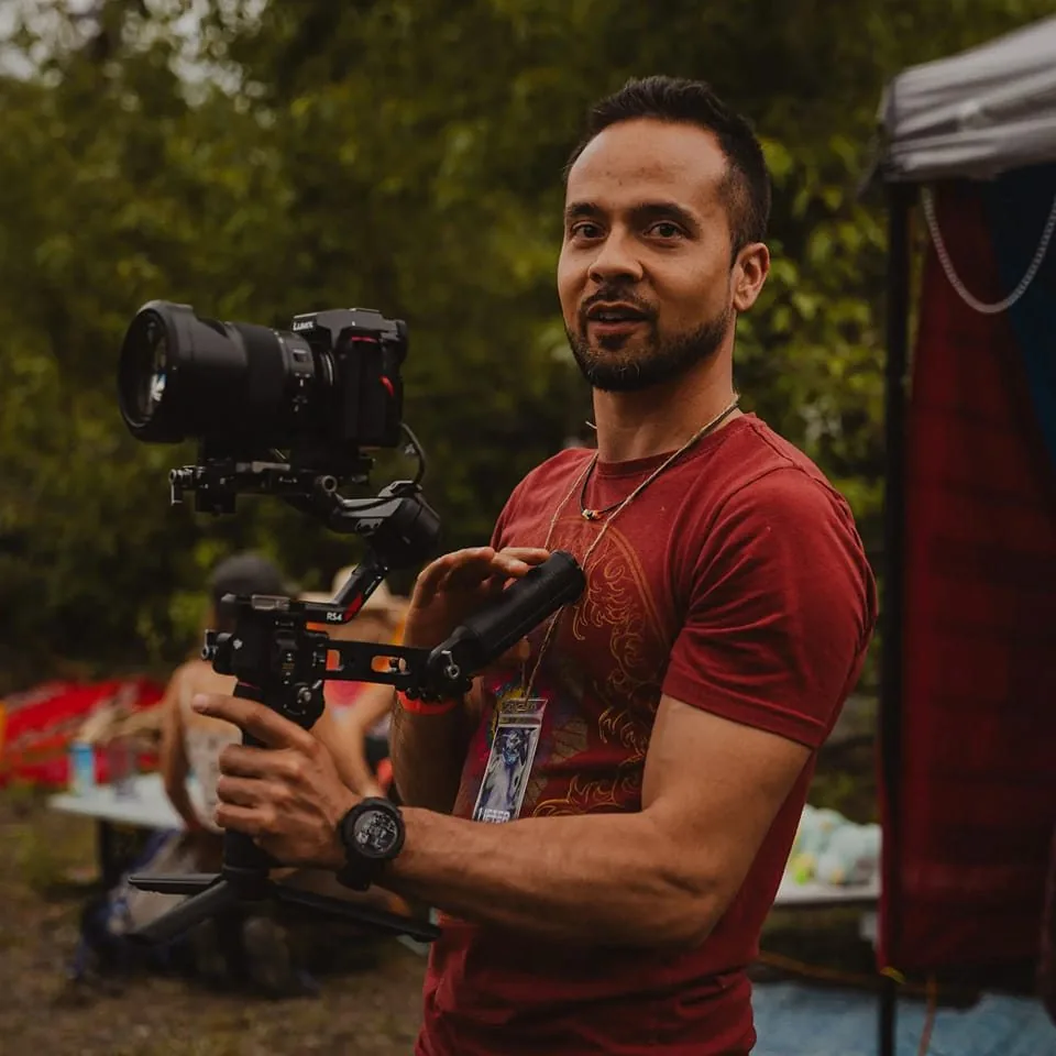 Zia holding a camera rig at an outdoor event